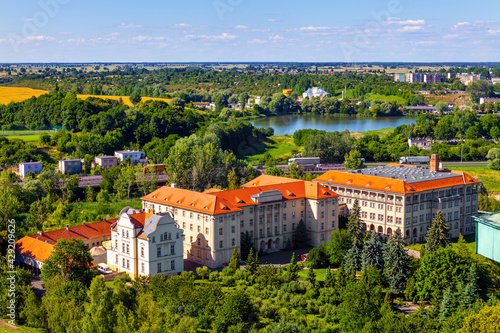 Panoramic aerial view of historic city center with Primate Seminary clerical complex and Jezioro Swietokrzyskie Lake in Gniezno, Poland photo