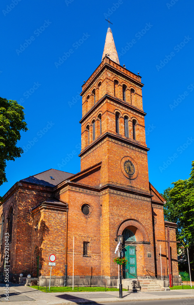 Fototapeta premium Church of Holy Virgin Mary Queen of Poland at Chrobrego street in old town historic city center of Gniezno in Grater Poland region