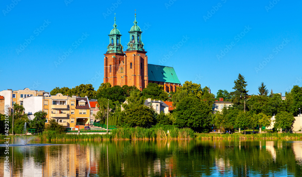 Cathedral of Virgin Mary Assumption and St. Wojciech at Lech Hill across Jelonek Lake in old town historic city center of Gniezno in Grater Poland Cathedral of Virgin Mary Assumption and St. Wojciech at Lech Hill across Jelonek Lake in old town historic city center of Gniezno in Grater Poland