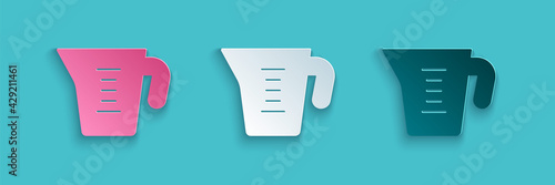 Paper cut Measuring cup to measure dry and liquid food icon isolated on blue background. Plastic graduated beaker with handle. Paper art style. Vector