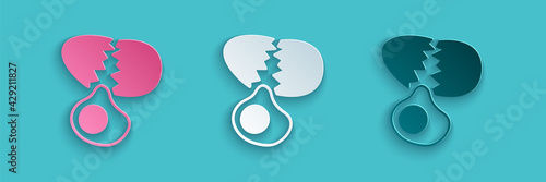 Paper cut Broken egg icon isolated on blue background. Happy Easter. Paper art style. Vector