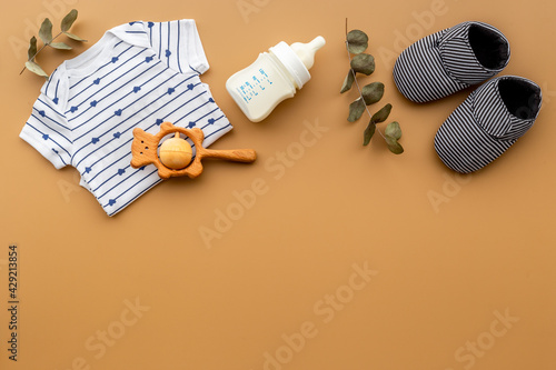 Baby accessories with bodysuit and shoes. Flat lay
