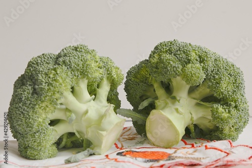 large heads of green fresh broccoli on napkin