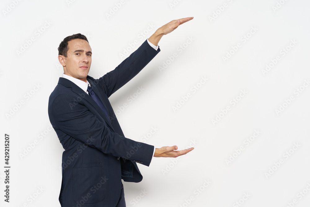 business man in a classic suit spreads his arms up and down finance manager business man in a classic suit spreads his arms up and down finance manager