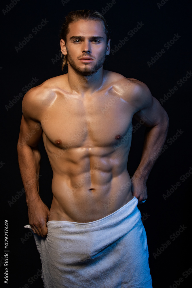 Fototapeta premium Sexy sport muscle fit strongface guy stripped on black isolated font background with smoke