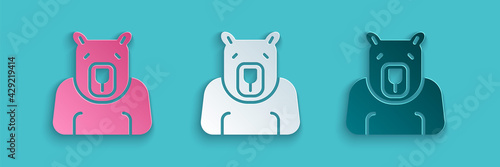 Paper cut Polar bear head icon isolated on blue background. Paper art style. Vector