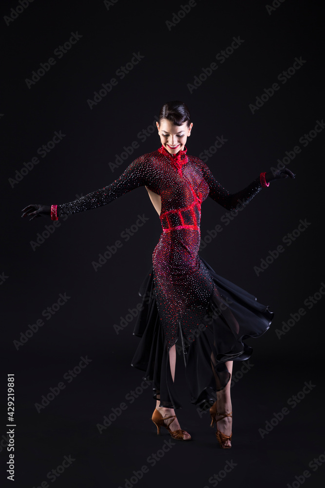 Beautiful young latino dancer woman in an amazing and shiny dress.