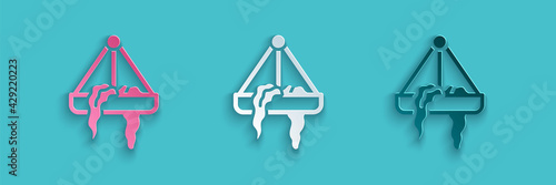 Paper cut Plant in hanging pot icon isolated on blue background. Decorative macrame handmade hangers for flower pot, hang indoor plants. Paper art style. Vector