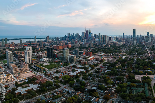 Aerial panoramic view of Toronto city skyline with streets  roads  infrastructure  residential areas and parks at dusk. Shot with drone. 