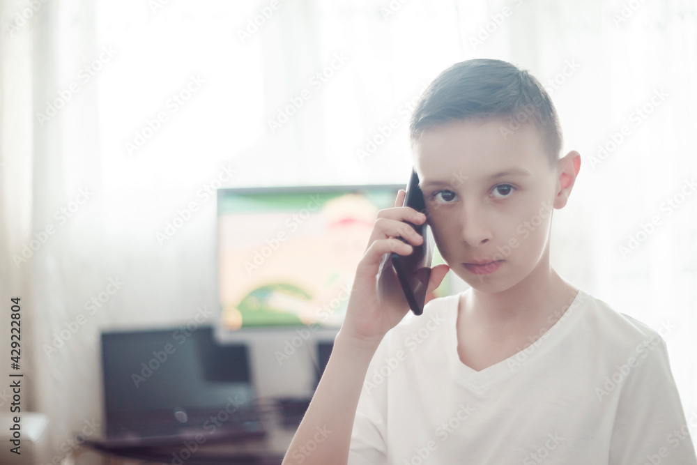 handsome boy holds a mobile phone handsome boy holds a mobile phone