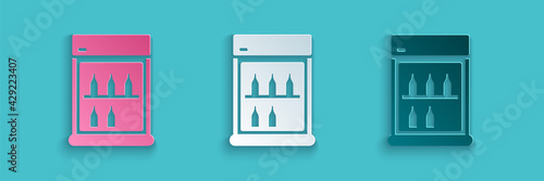 Paper cut Commercial refrigerator to store drinks icon isolated on blue background. Perishables for store or supermarket. Paper art style. Vector