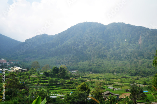 View landscape mountain and Rajaberneh city valley village hill with plantation farm of indonesian people in Sibayak mount at Jaranguda Merdeka of Karo at Sumatera Utara or North Sumatra, Indonesia