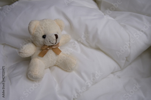 Teddy bear on the bed. Toy. The interior. Children's soft toy.