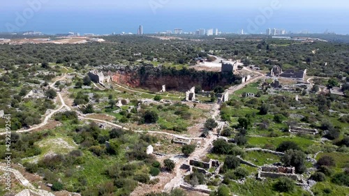 Aerial shot of Kanlidivane (Canytelis), an ancient city situated around a big sinkhole in Mersin Province, Turkey. photo