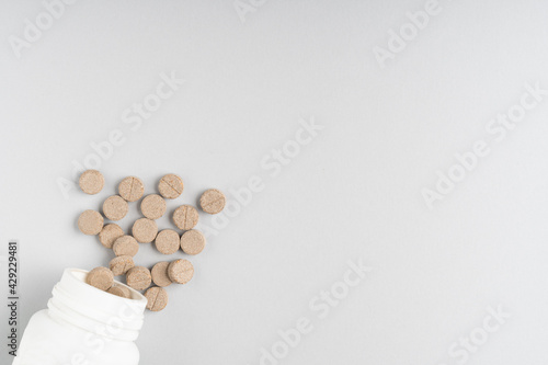 Herbal pills on gray background, top view. Different medicines, tablets, medicine capsules. Medicine concept, background. Text place