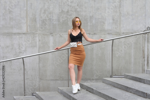 young fashionable girl in clothes on the street