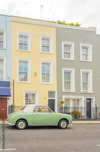 July 2020. London. Colourful buildings and Nissan Figaro car in Notting Hill, London, England