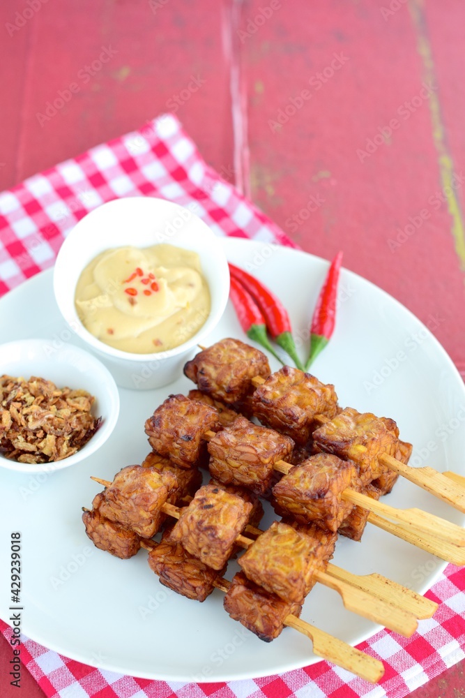 Tempeh Skewers served with spicy peanut sauce and fried onion Tempeh Skewers served with spicy peanut sauce and fried onion