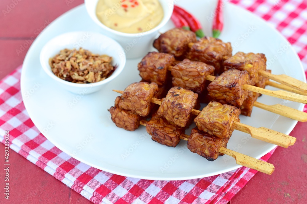 Tempeh Skewers served with spicy peanut sauce and fried onion