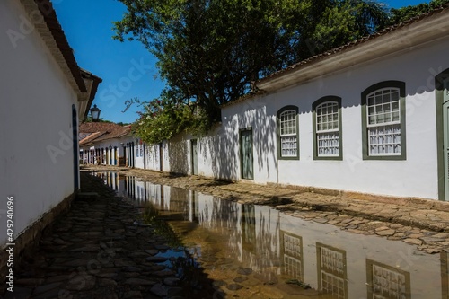 Colonial houses and flooded stone street by sea waters in the historic center of the city of Paraty.