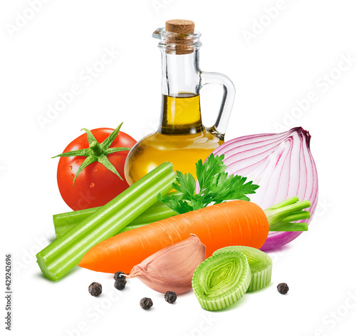 Bottle of olive oil, tomato, purple onion, celery, leek, carrot, herbs, garlic cloves and black pepper isolated on white background.