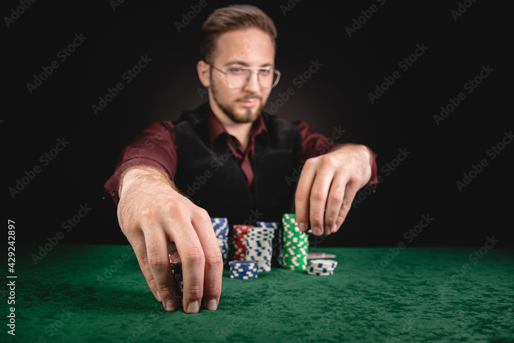 Young gentleman giving bet in poker Young gentleman giving bet in poker