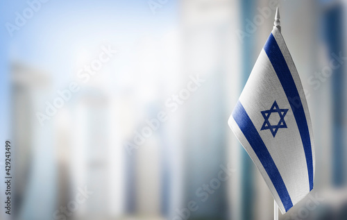 Quadro su tela A small flag of Israel on the background of a blurred background