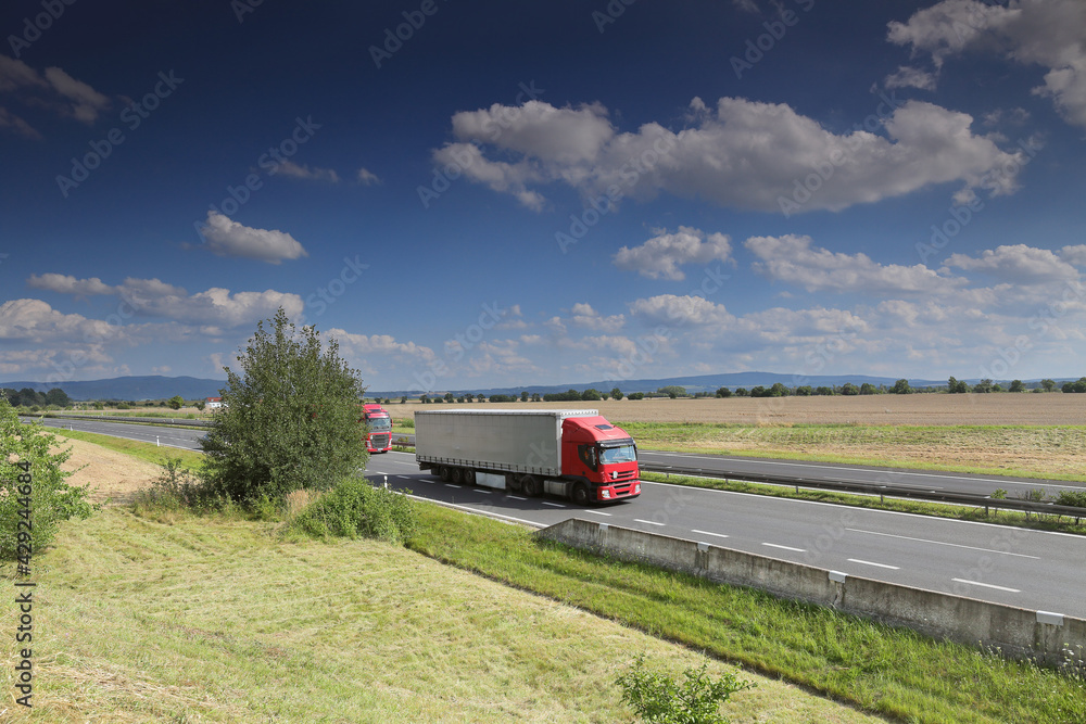 Landscape with a moving truck on the highway. 