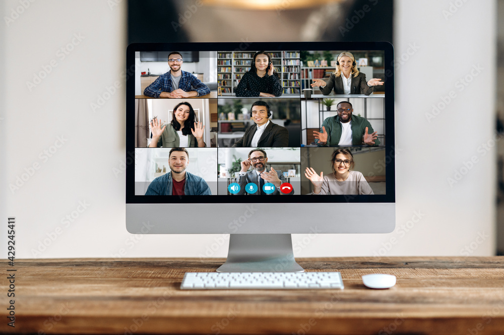 Online video conference communication. View of a computer monitor with diverse multiracial successful business partners from different parts of the world gathered to discuss business issues Online video conference communication. View of a computer monitor with diverse multiracial successful business partners from different parts of the world gathered to discuss business issues
