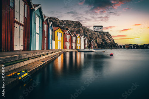 Sweden houses, small colorful fishermen's houses in Sweden smog. A great city right by the sea with a rock in the background, smögen  photo