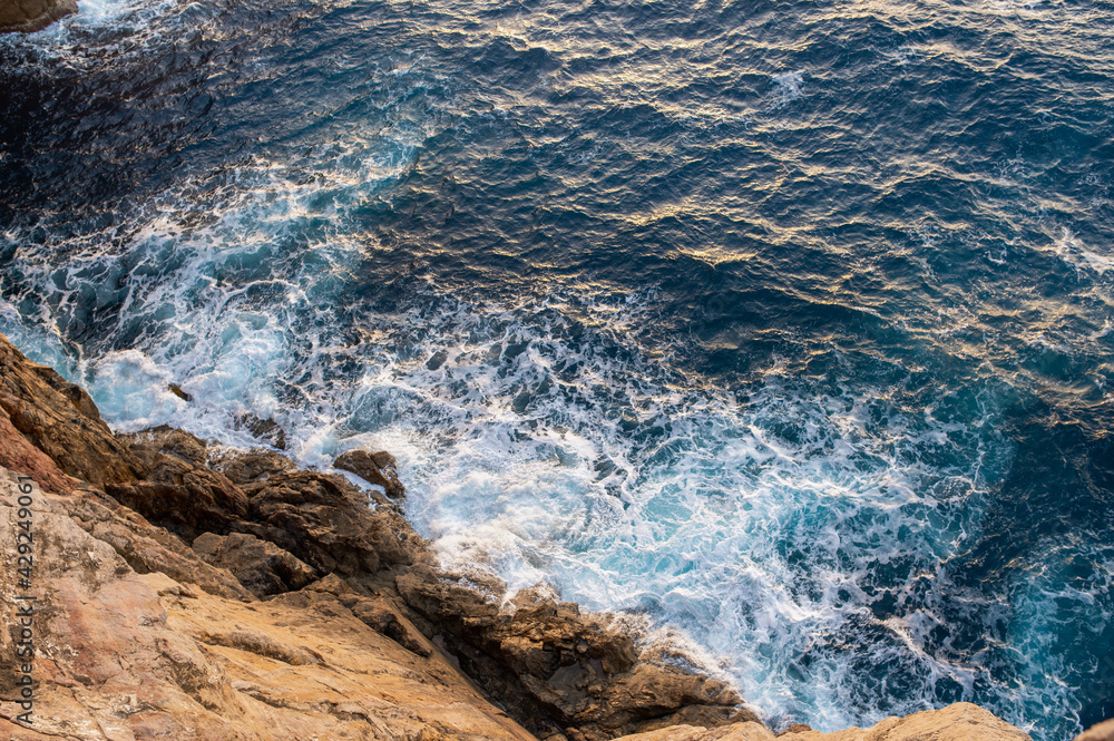 Wave breaking on the rock. View from above.