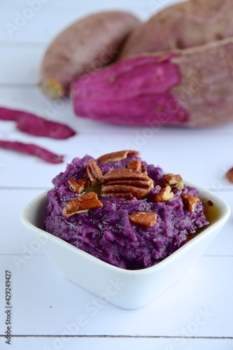 Mashed purple sweet potato with pecan nuts and maple syrup photo