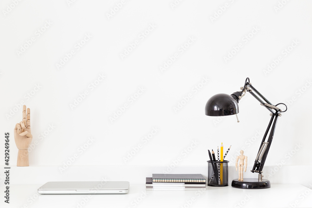 Creative desk with blank space for product, poster, desk objects, office supplies, books and plant on a bright background.
Creative desk with blank space for product, poster, desk objects, office supplies, books and plant on a bright background.