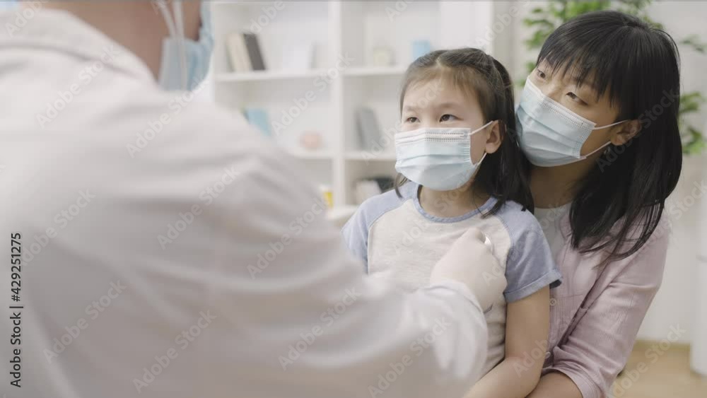 Chinese mother and little daughter attending regular health checkup in hospital Chinese mother and little daughter attending regular health checkup in hospital