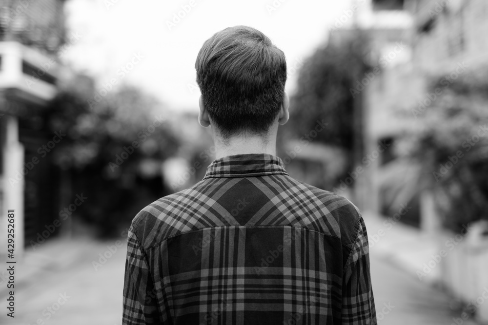 Portrait of young handsome hipster man outdoors in black and white Portrait of young handsome hipster man outdoors in black and white