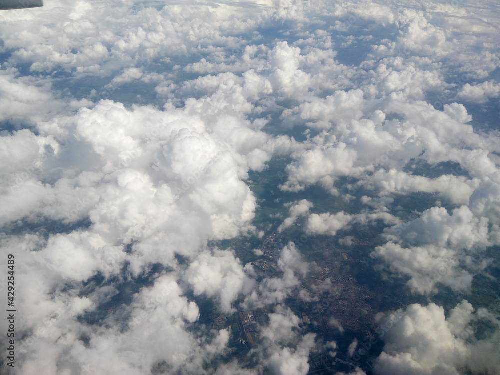 Scenic view from the airplane window. Natural beauty of blue sky with clouds. Wing of the plane. Airplane flying in the sky. Scenic view from the airplane window. Natural beauty of blue sky with clouds. Wing of the plane. Airplane flying in the sky.