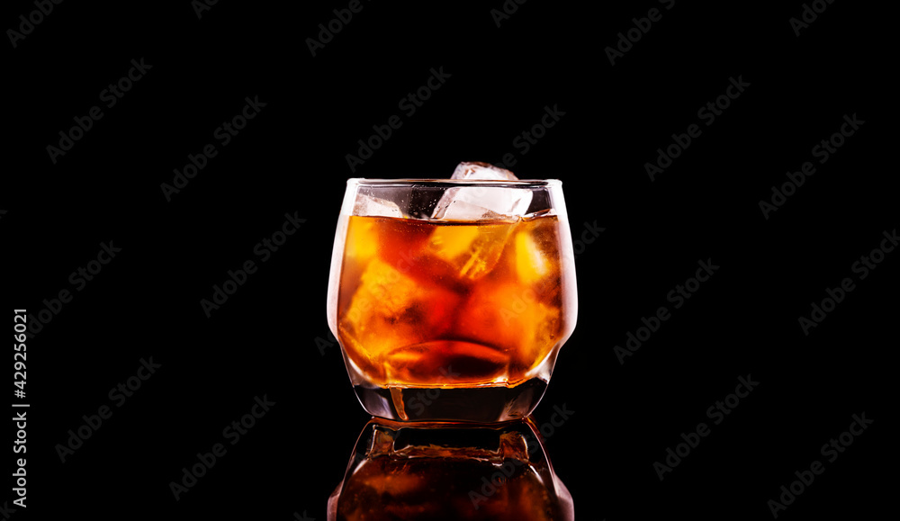 glasses of whiskey or cola with ice cubes isolated on black background
