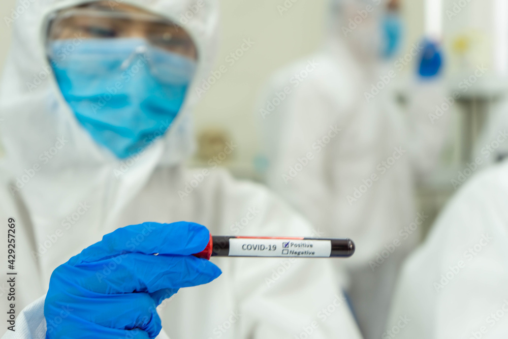 Asian medical scientists in PPE protective suit research for virus pandemic vaccine in clinical laboratory Asian medical scientists in PPE protective suit research for virus pandemic vaccine in clinical laboratory