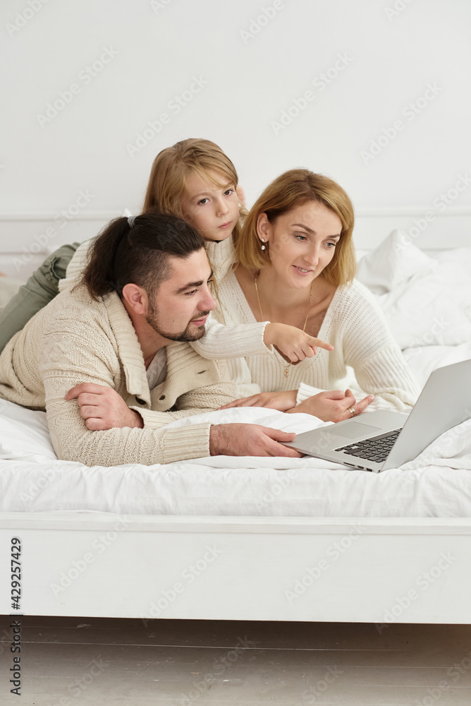 family with baby looking at laptop