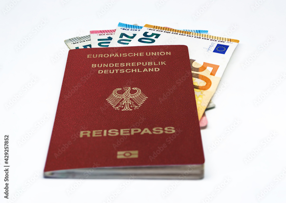 German travel passport with some euro banknotes isolated on a white background German travel passport with some euro banknotes isolated on a white background