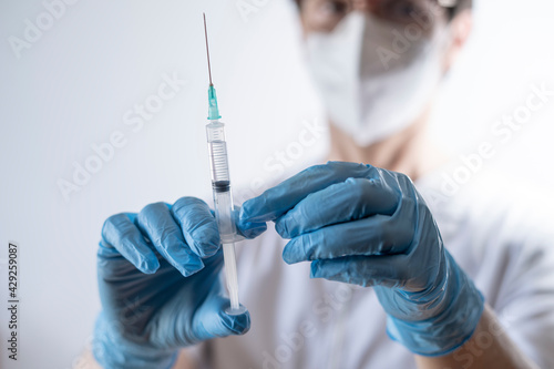 nurse preparing syringe for vaccination