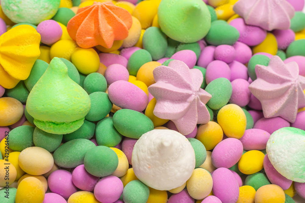 Colorful meringues and glazed peanuts isolated on a white background. Colorful meringues and glazed peanuts isolated on a white background.
