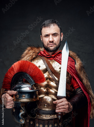 Imperial soldier holding helmet and short sword