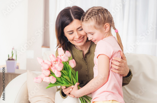Loving teen little girl preparing surprise for mother on Mothers day, 12th may