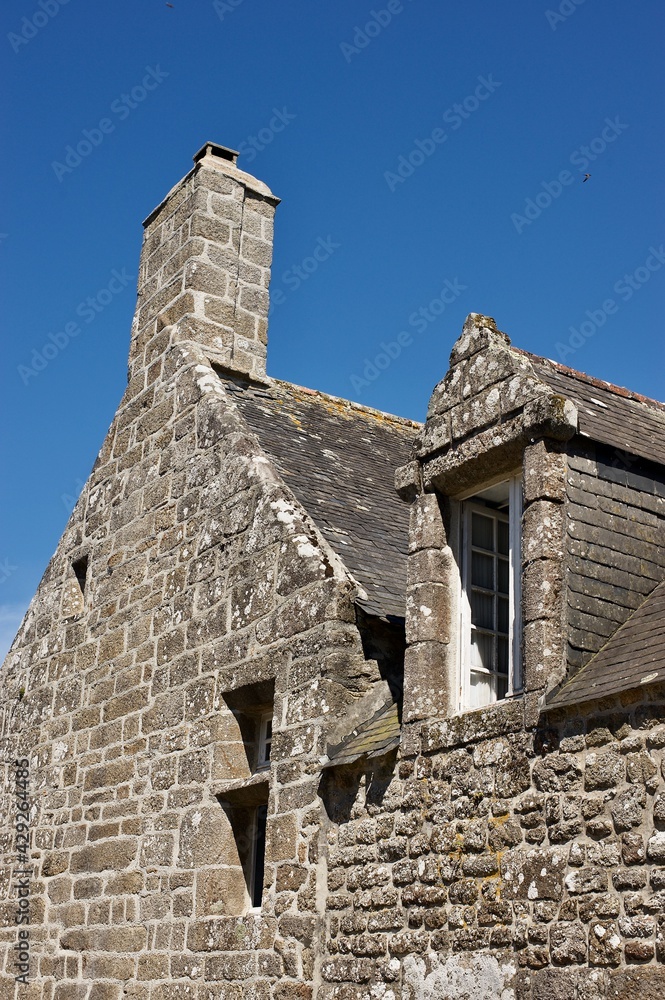 old granite breton house with opened window