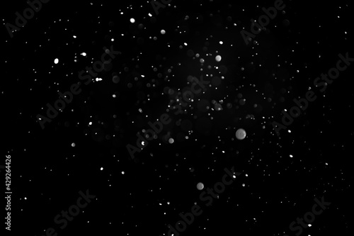 Snowflakes on a dark background. Overlay to apply to a photo. defocused raindrops