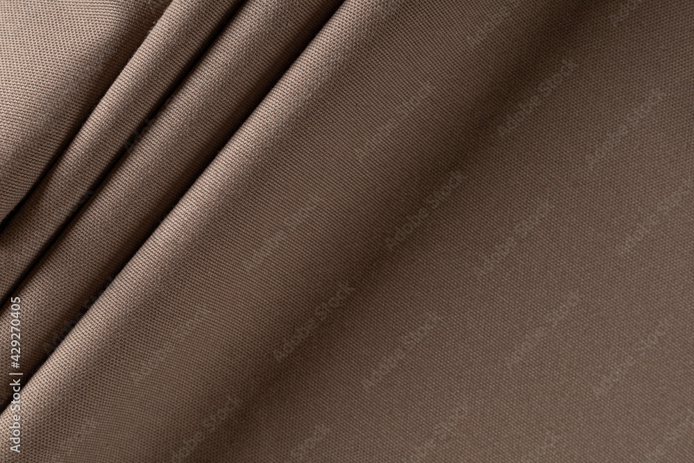 Fototapeta premium thick curtain cotton fabric of coffee color, folded in folds, background