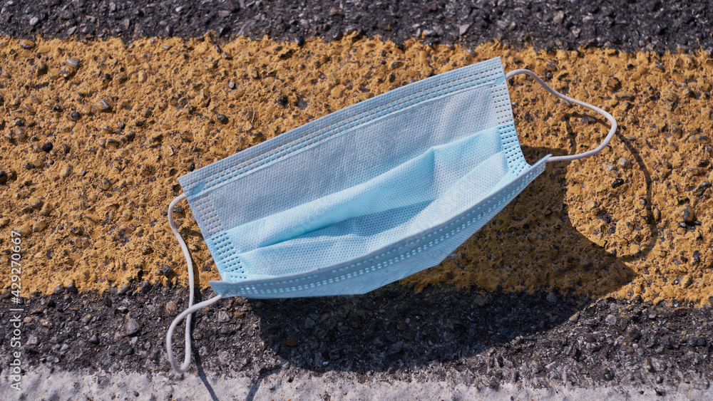 A standard mask left on the asphalt. Yellow zone its near. A standard mask left on the asphalt. Yellow zone its near.