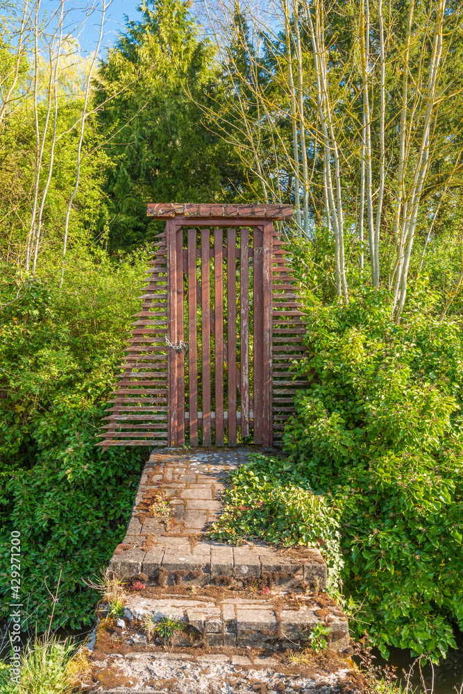 An old entrance door on the small bridge over canal in Amiens, France. An old entrance door on the small bridge over canal in Amiens, France.
