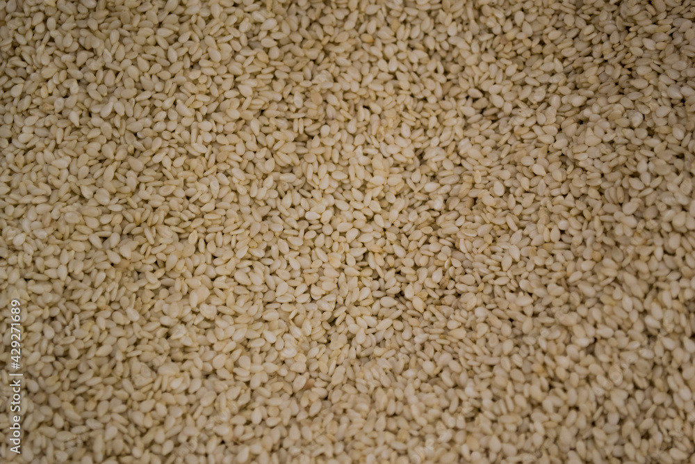 Lots of white dried sesame seeds. Simple food background Lots of white dried sesame seeds. Simple food background
